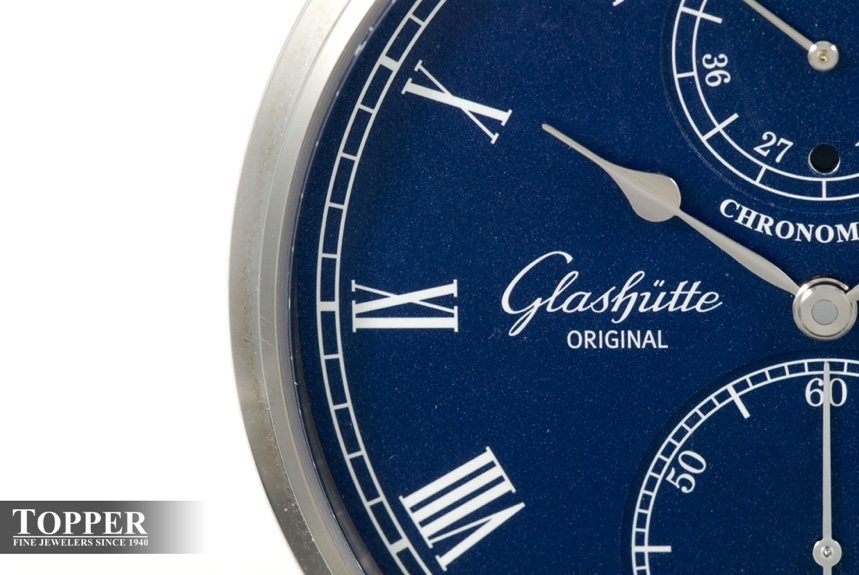 The minute track, Arabic numeral hour markers, and Glashutte Original signage. 